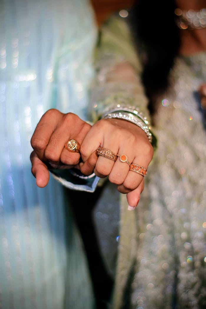 Close-up of a couple's hands showcasing traditional rings at a Pakistani wedding.